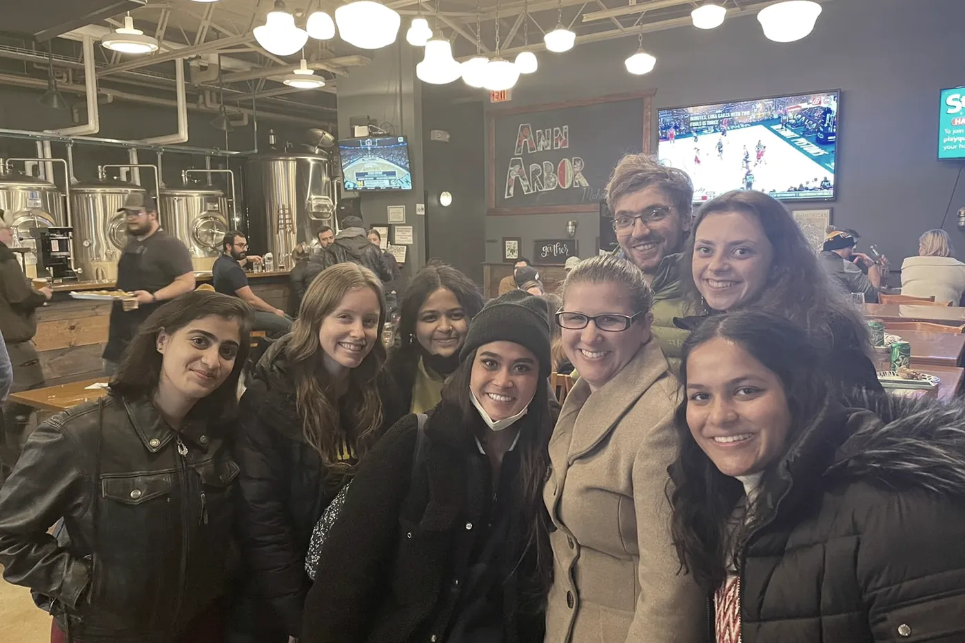 Lab members crowded together at a brewery