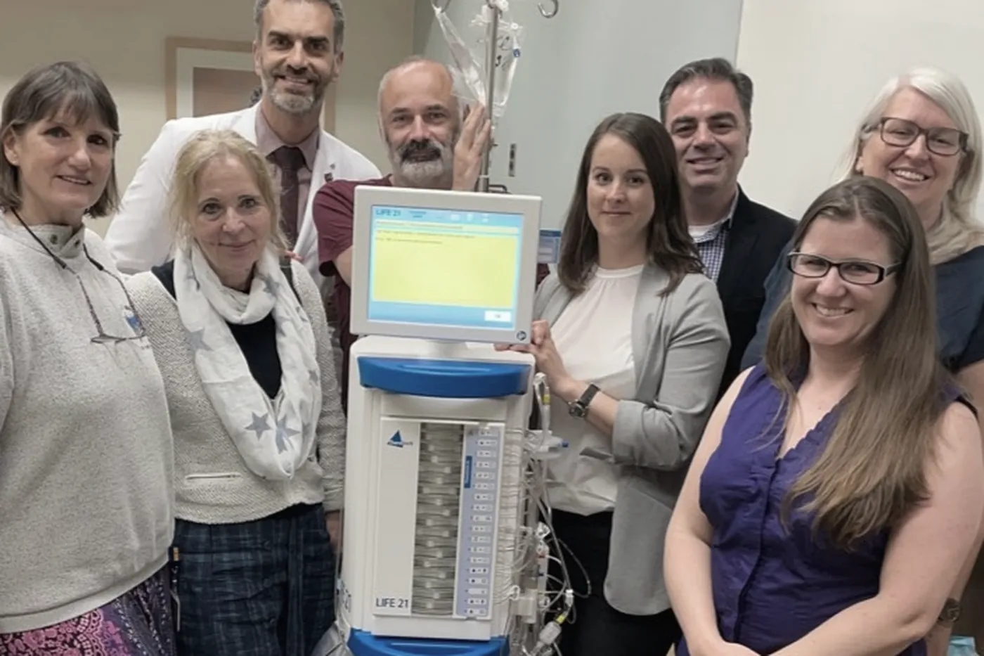 Lab members gathered around a newly delivered laboratory analyser