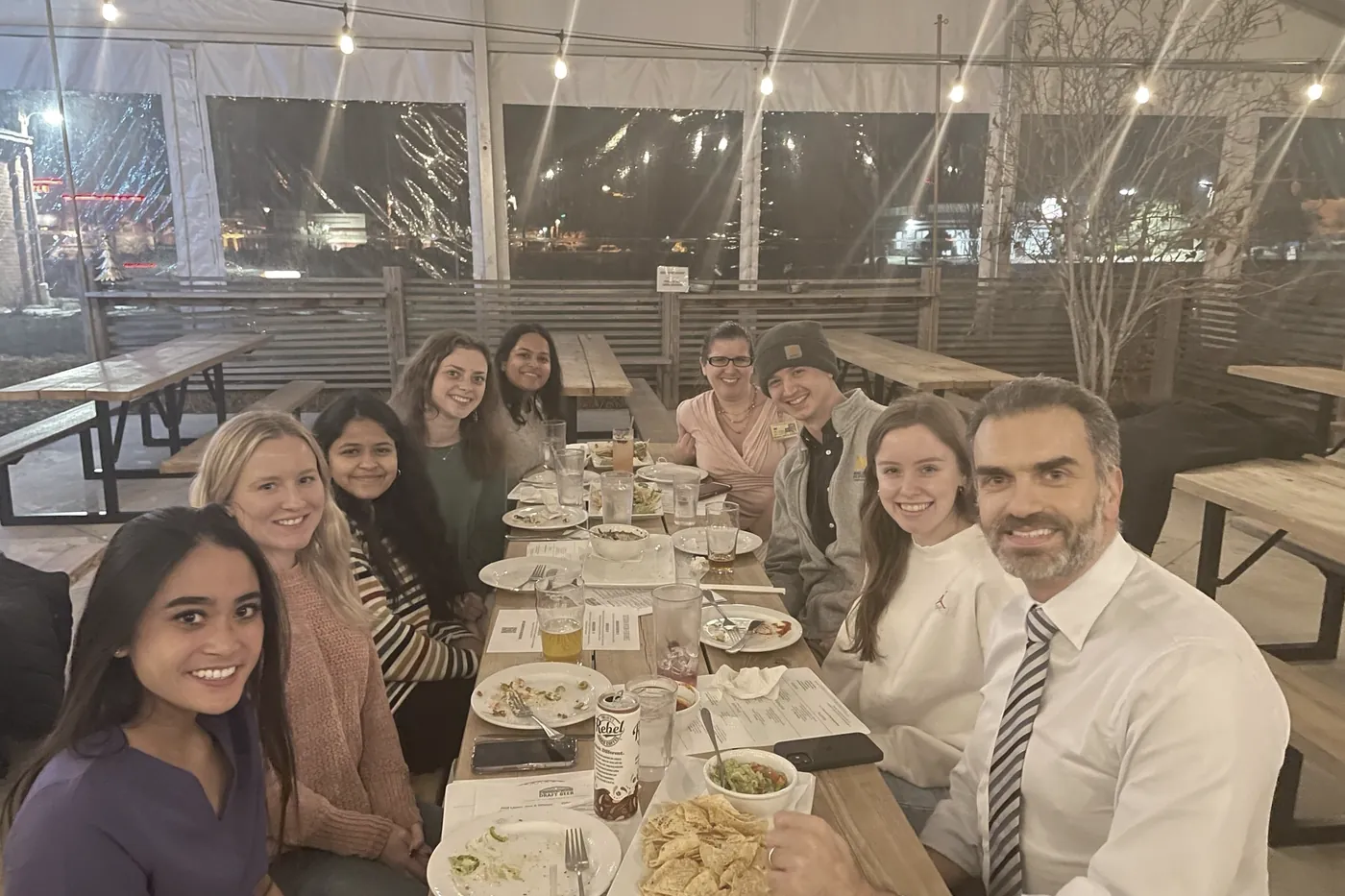The team along a long table at an evening dinner